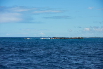 Obraz premium Coin de Mire reef (Gunner's Quoin), a protected Mauritian island 8 km off Mauritius' northern coast, is known for its steep profile and birdlife but is not open to visitors.