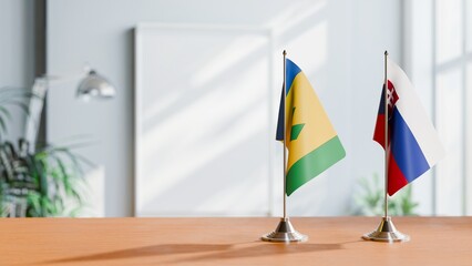 FLAGS OF SAINT VINCENT AND SLOVAKIA ON TABLE