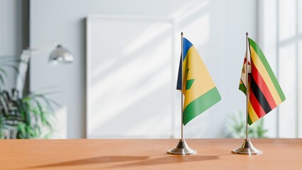 FLAGS OF SAINT VINCENT AND ZIMBABWE ON TABLE