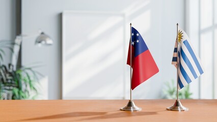 FLAGS OF SAMOA AND URUGUAY ON TABLE