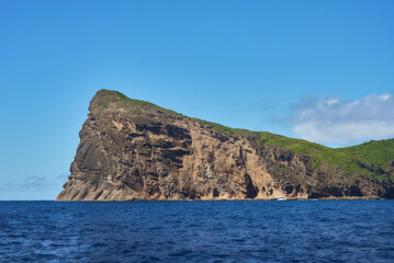 Coin de Mire (Gunner's Quoin), a protected Mauritian island 8 km off Mauritius' northern coast, is known for its steep profile and birdlife but is not open to visitors.