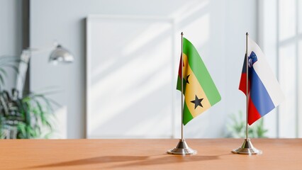 FLAGS OF SAO TOME AND SLOVENIA ON TABLE