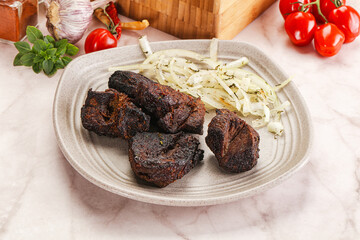 Grilled beef barbecue served onion