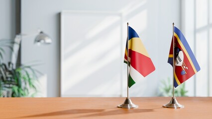 FLAGS OF SEYCHELLES AND SWAZILAND ON TABLE