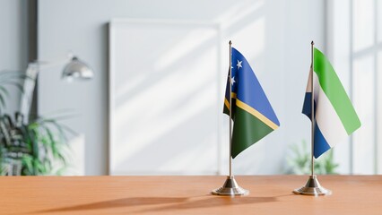 FLAGS OF SIERRA LEONE AND SOLOMON ISLANDS ON TABLE