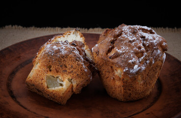 Cut muffin on a clay plate. Fresh delicious muffin.
