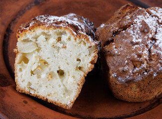 Cut muffin on a clay plate. Fresh delicious muffin.