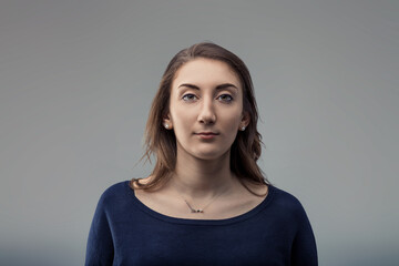 Young woman staring at camera with neutral expression