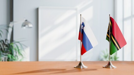 FLAGS OF SLOVENIA AND VANUATU ON TABLE