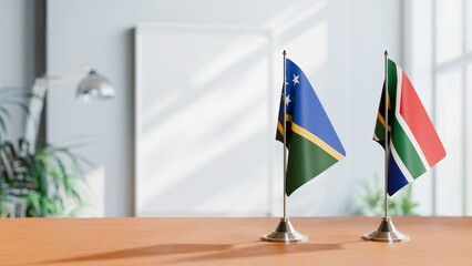 FLAGS OF SOLOMON ISLANDS AND SOUTH AFRICA ON TABLE