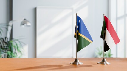 FLAGS OF SOLOMON ISLANDS AND SUDAN ON TABLE