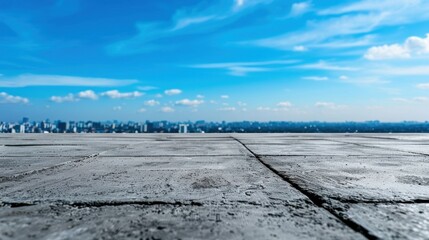 Fototapeta premium A vast, open sky over a concrete surface, showcasing a panoramic view of distant city buildings and a serene atmosphere.