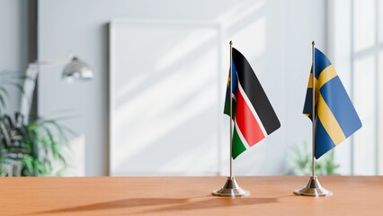 FLAGS OF SOUTH SUDAN AND SWEDEN ON TABLE