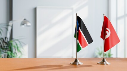 FLAGS OF SOUTH SUDAN AND TUNISIA ON TABLE