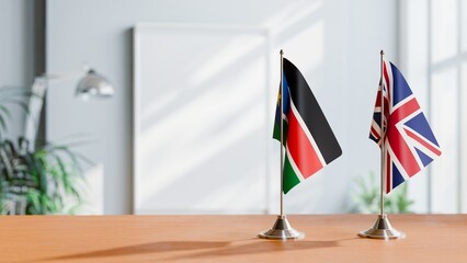 FLAGS OF SOUTH SUDAN AND UNITED KINGDOM ON TABLE