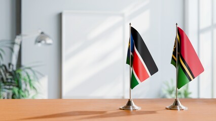 FLAGS OF SOUTH SUDAN AND VANUATU ON TABLE