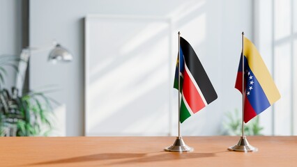 FLAGS OF SOUTH SUDAN AND VENEZUELA ON TABLE