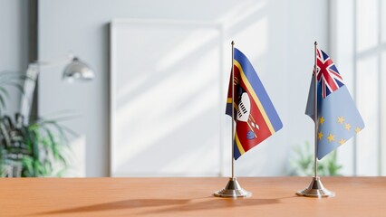 FLAGS OF SWAZILAND AND TUVALU ON TABLE