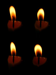 Set of isolated candle flames on black background. Candle flames are burning at night in close-up.