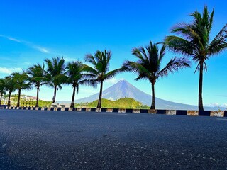 Legazpi City Boulevard with a coconut tree and view of mayon volcano in legazpi city albay philippines

