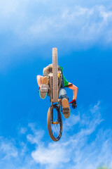 boy jumping with his dirk bie over a ramp