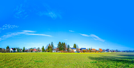 Obraz premium suburban area of munich with fields and family houses at horizon, Munich, Germany