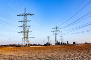 hight voltage tower in rural landscape with blue sky