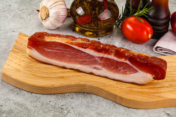 Piece prosciutto crudo over board