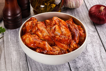Raw marinated buffalo chicken wings
