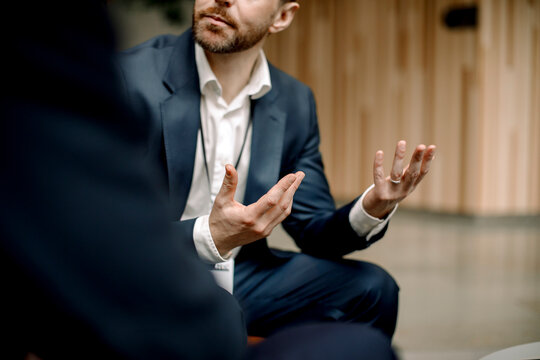 Hands of businessman discussing through hand gestures at convention center