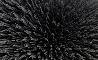 Reaction of iron dust to a magnetic field. Iron filings spikes. Neodymium magnet. Isolated on a...