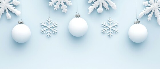 Winter-themed decorations with white ornaments and snowflakes on a light blue background.