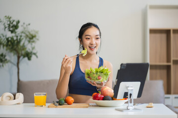 Fit woman enjoys healthy fruit breakfast after yoga training. fitness, nutrition, healthy lifestyle.