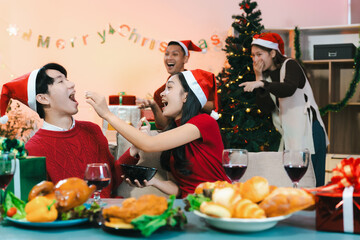 drinks and conversation, people celebrating together at Merry Christmas and Happy New Year. Friends are happy and celebrating with food, wine and friendship of love and gift exchange at the event.