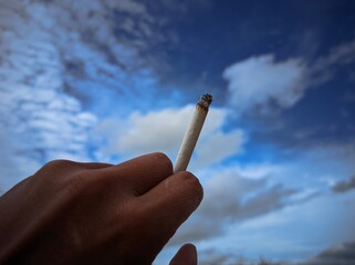 hand holding a cigarette, commemorating world health day, stop smoking for health