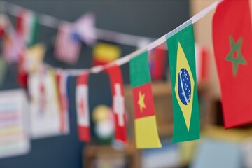 Close up background image of various country flags decorating school classroom or kindergarten room...