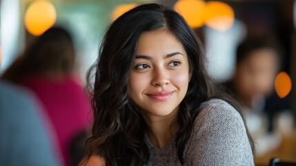 Obraz premium Beautiful girl sitting at restaurant table looking at someone