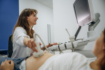 With big belly. Pregnant woman undergoing ultrasound test