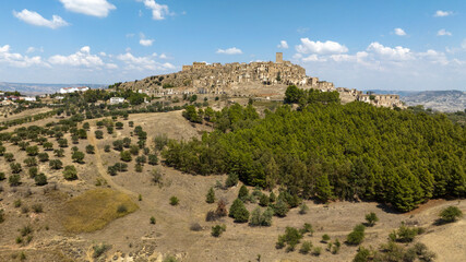 Aerial view of Craco, a ghost town in the province of Matera, Basilicata, Italy. The historic center was depopulated due to a landslide and has become a tourist destination.
