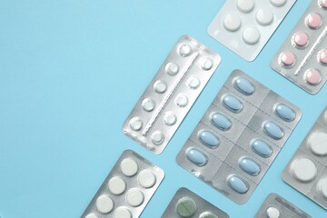 Various blisters with tablets on a colored background