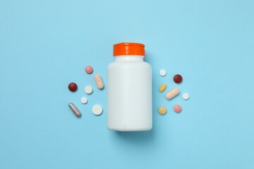 Various pills with bottle on colorful background