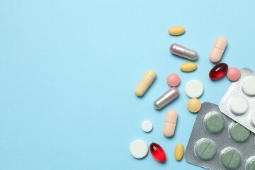 Various blisters with tablets on a colored background