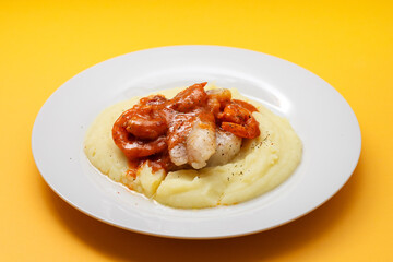 Fried fish with mashed potato and sauce on plate