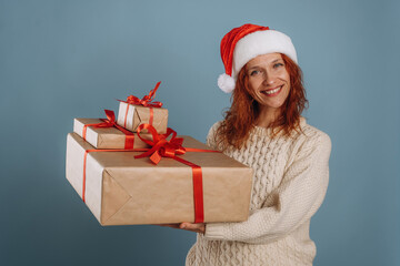 Happy holidays, holding New Year presents. Woman is in the studio against background