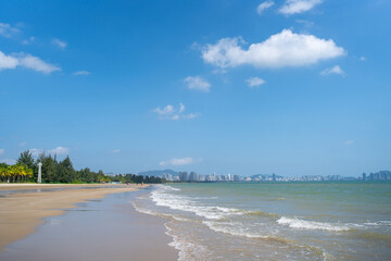 Experience a Serene Beach View With Gentle Waves Lapping Against The Shore and a Clear Sky