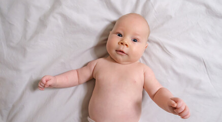 Joyful Two-Month-Old Baby Boy on a Light Background. Selective Focus