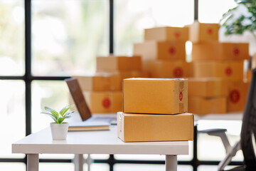 Equipments for SME online business , delivery business laptop, barcode, boxes, checking product on stocks or parcels. Small business working at home office.
