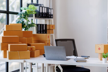 Equipments for SME online business , delivery business laptop, barcode, boxes, checking product on stocks or parcels. Small business working at home office.
