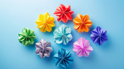 Fototapeta premium A colorful set of multicolor handmade modular origami balls (kusudama) isolated on a vibrant blue background, showcasing the intricate art of Japanese paper folding.