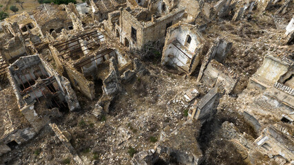Aerial view of abandoned and destroyed houses in Craco, ghost town in province of Matera, Basilicata, Italy. The historic center was depopulated due to a landslide and has become a tourist destination